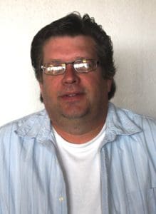 Man in glasses, light blue shirt.