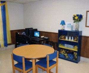 A room with blue chairs and tables in it