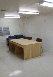 A room with a table and chairs in it