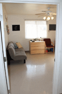 A living room with a couch and chair in it