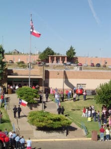 A group of people standing around in front of a building.