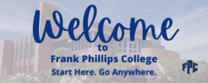 A blue welcome sign sitting in front of a building.