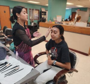 A woman is getting her face painted