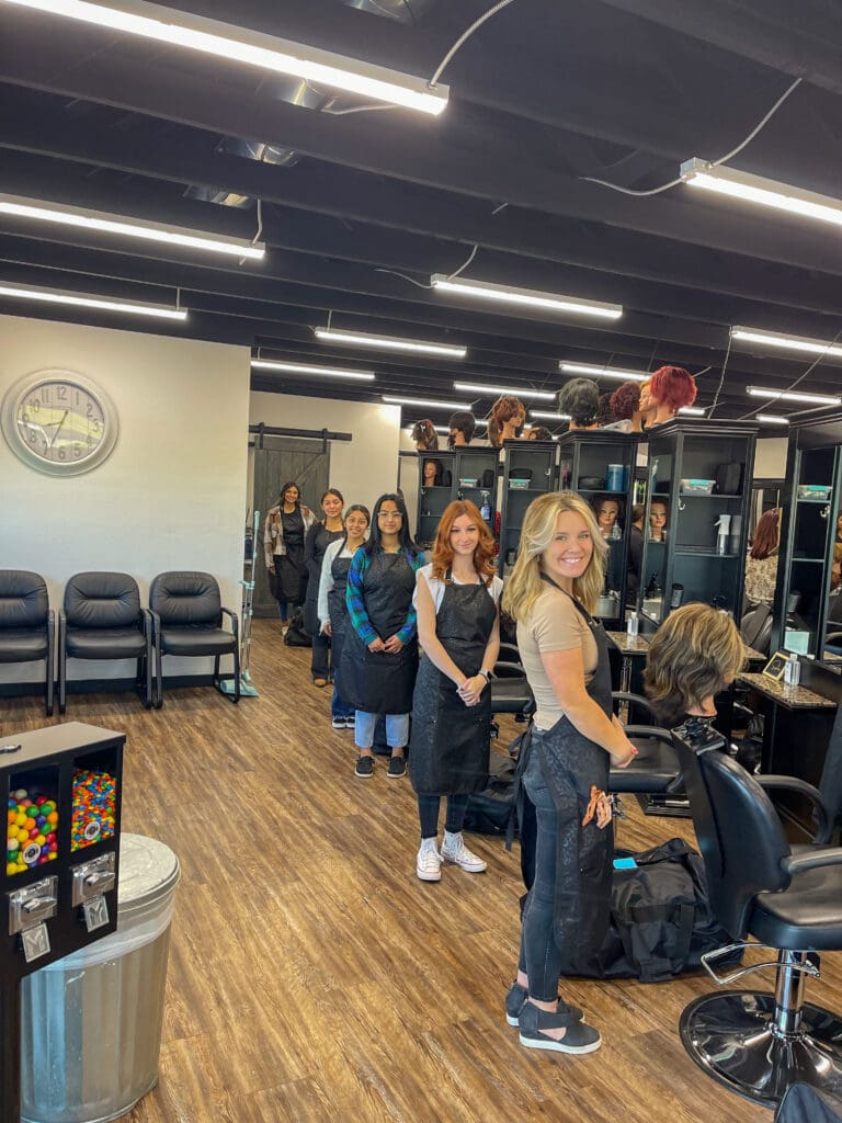 A group of women standing in front of some chairs.