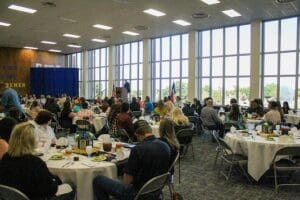 A large group of people sitting at tables.