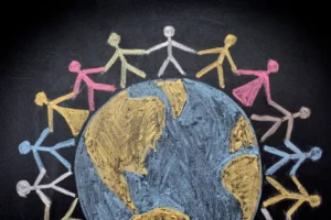 A chalkboard drawing of people holding hands around the world.