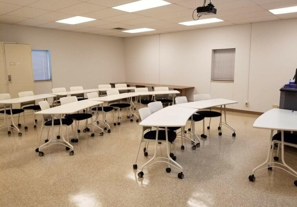 Classroom 2b A room with many tables and chairs in it