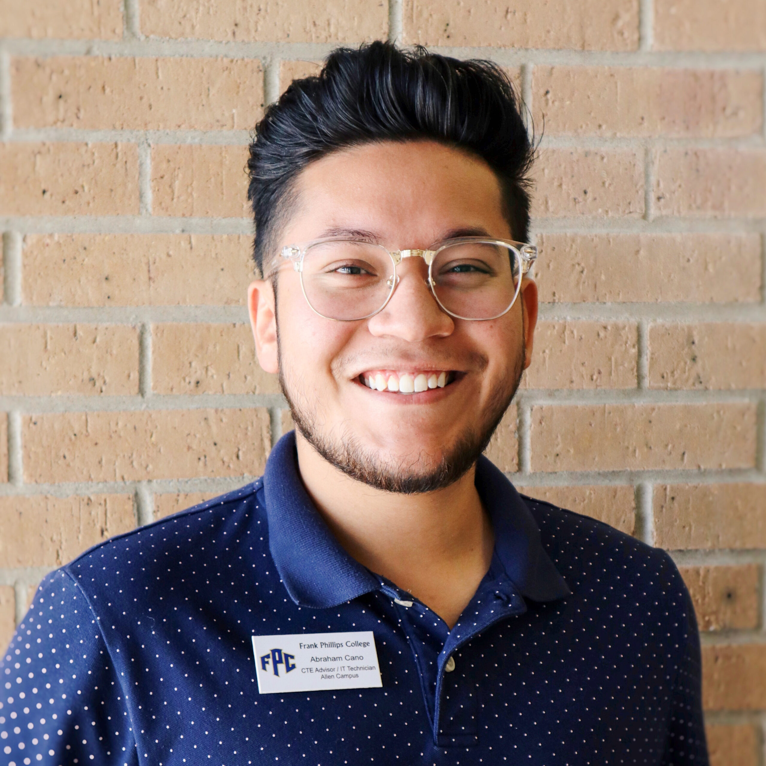 A man with glasses and a blue shirt