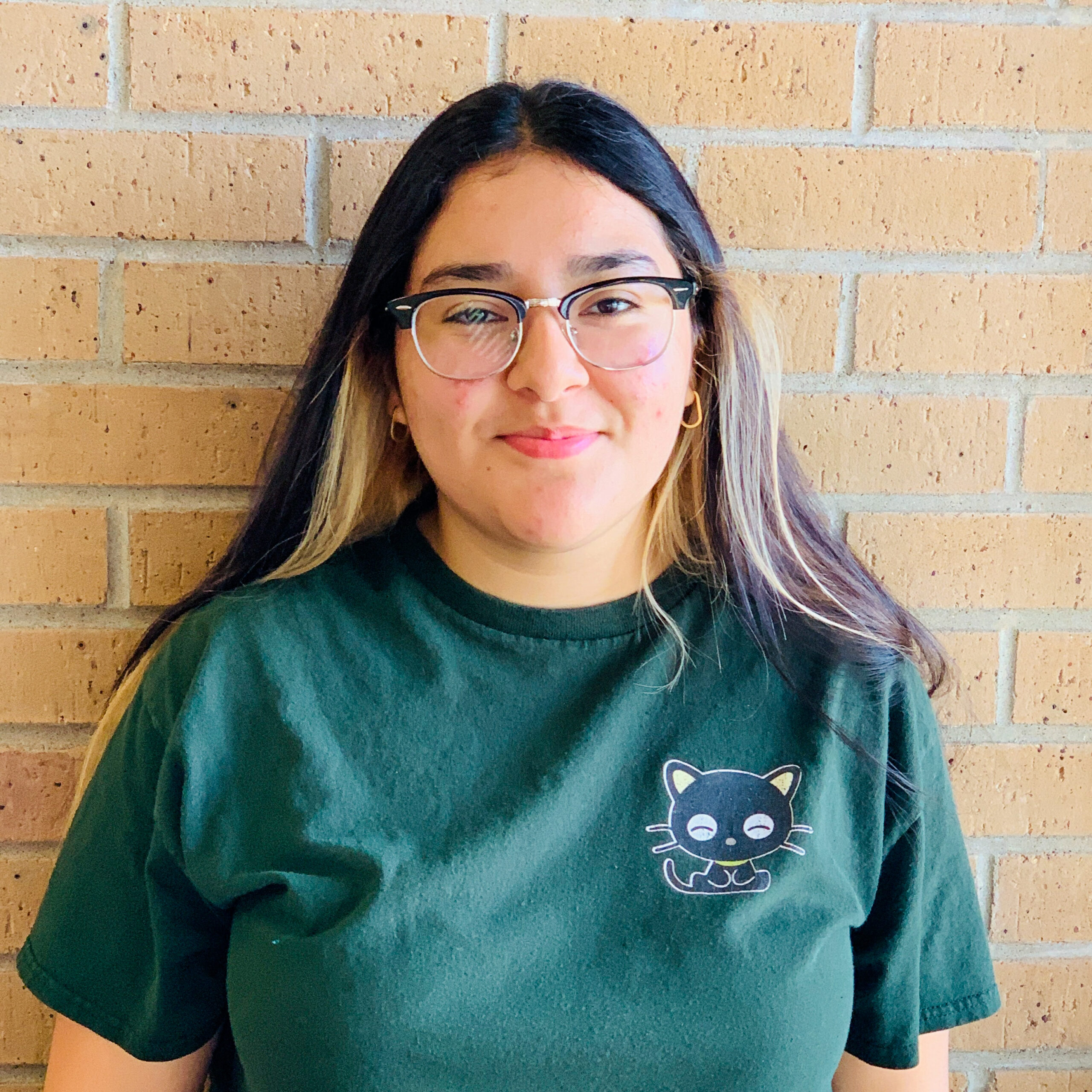 A woman wearing glasses and a green shirt.