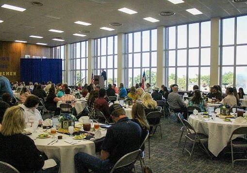 Library A large group of people sitting at tables.